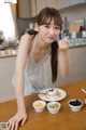 A woman sitting at a table with a plate of food.