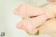 A woman's feet in a bathtub filled with water.