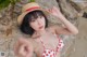 A woman in a red and white bikini and a straw hat.