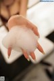 A woman is washing her hands with foam. 