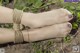 A woman's feet tied up with a rope.