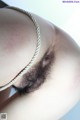 A close up of a woman's thigh with a chain around her neck.