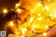 A woman laying on top of a bed covered in lights.