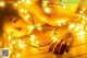 A naked woman laying on a wooden floor covered in lights.