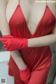 A woman in a red dress and red gloves.