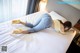 A woman laying on top of a bed in a hotel room.