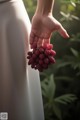 A person holding a bunch of raspberries in their hand.