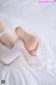 A close up of a person's feet on a bed.